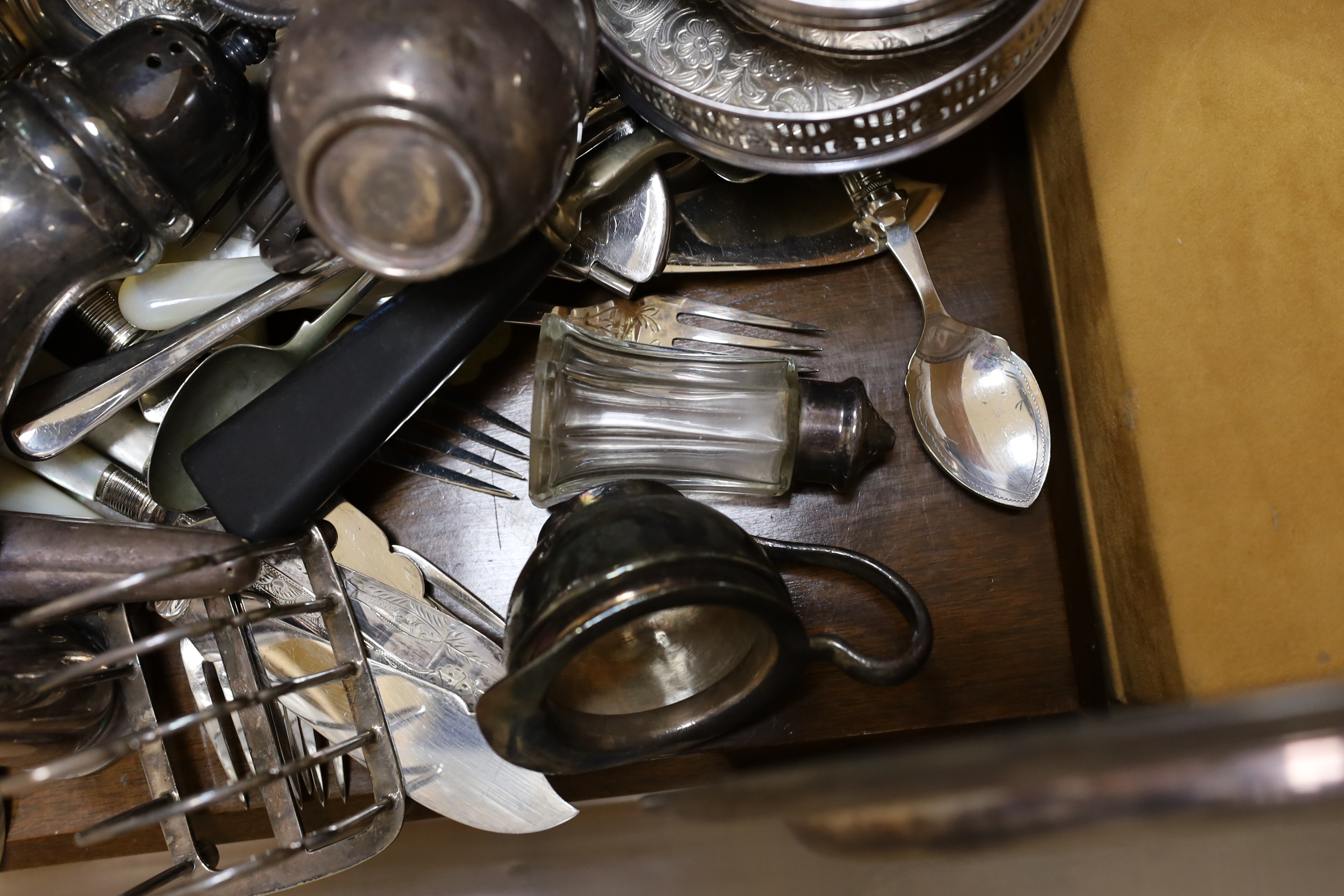 A large quantity of assorted plate wares including an Elkington & Co bottle pourer, a model yacht, two hip flasks, flatware, chambersticks, etc.